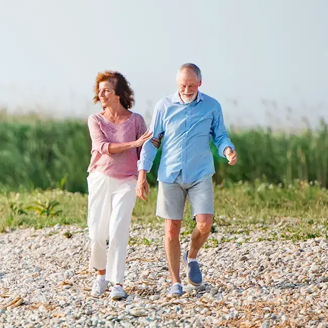 Retired walking on the beach
