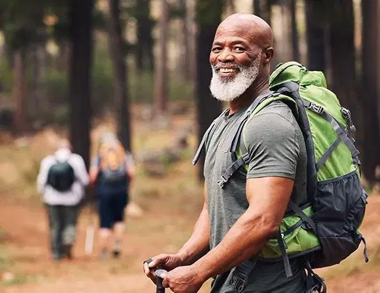 Male hiker on mountain top smiling